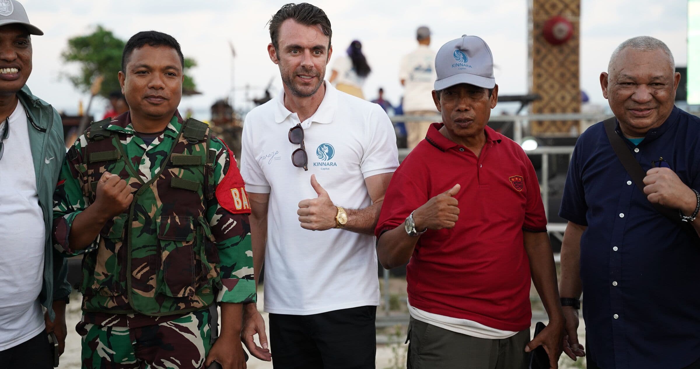 Adrian Campbell giving a thumbs up alongside village leaders, local officials and military representatives at the Saraya community day in Sekotong, West Lombok.